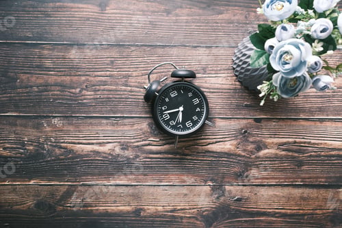 Preview: old alarm clock on wooden table top view