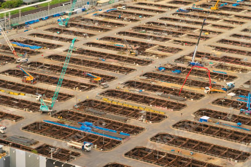 Preview: Busy industrial under construction site workers working and excavators. Top view of precast concrete