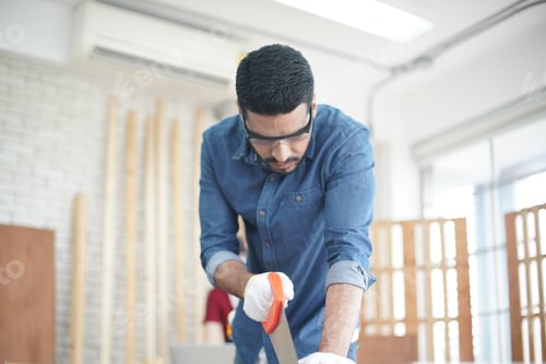 Preview: Carpenter or warehouse worker choosing raw wood material for the work at the carpentry storage