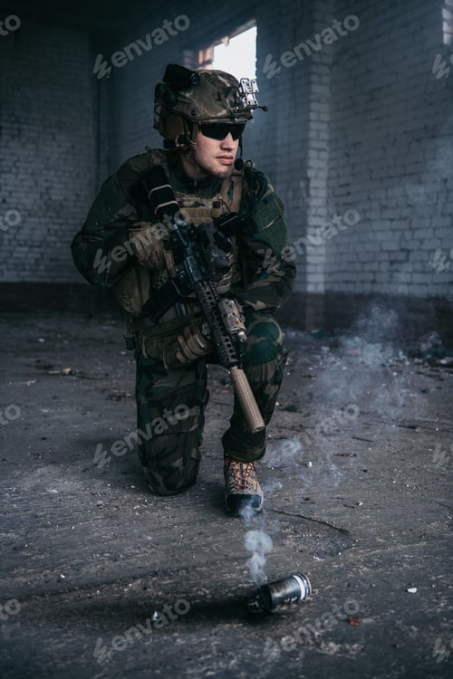 Preview: Military man during combat and smoke grenade on a ground