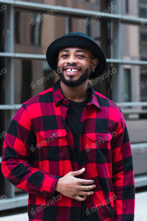 Preview: Man portrait. Style. Handsome Afro American guy in red jacket is looking at camera and smiling
