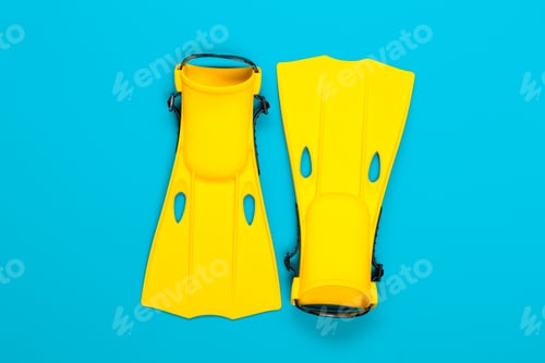 Preview: Bright yellow swim fins against a blue background for snorkeling and diving activities
