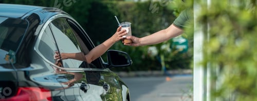 Preview: Hand Man in car receiving coffee in drive thru fast food restaurant.