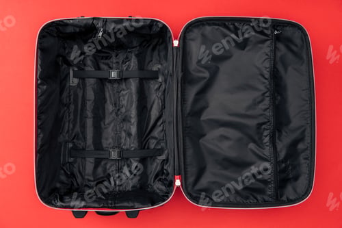 Preview: top view of empty travel bag isolated on red