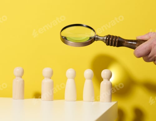 Preview: Figurines of men on a white table and magnifying glass