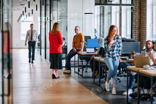 Preview: A diverse group of young business individuals congregates in a modern startup coworking center