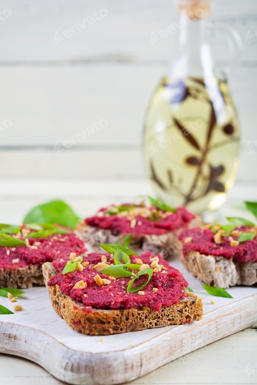 Preview: Toasts with beetroot, chopped nuts and herbs. Vegan bruschetta with beet