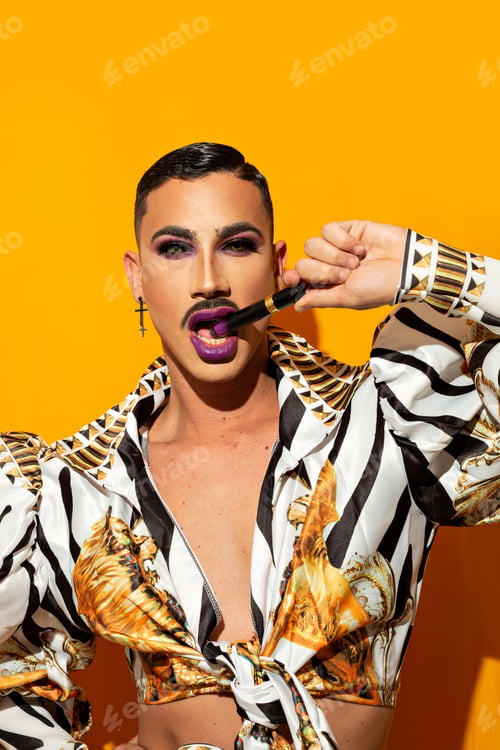 Preview: beautiful drag queen portrait biting lipstick on a yellow background
