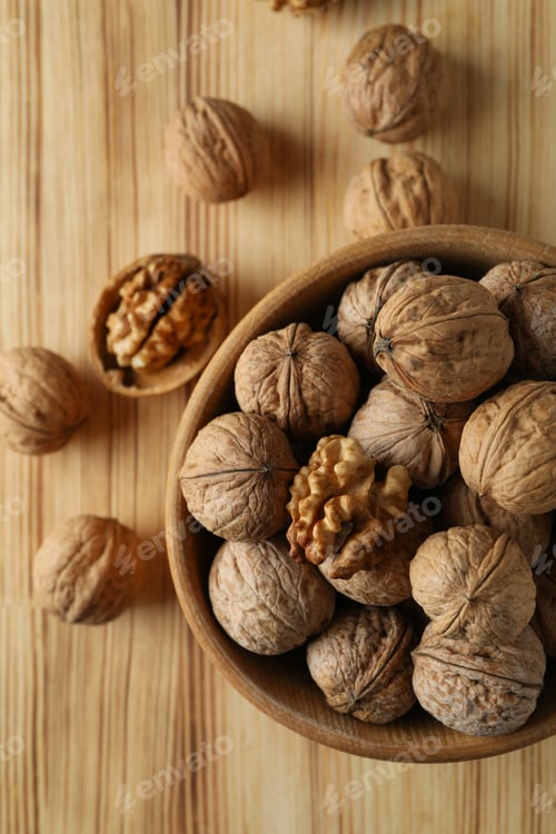 Preview: Walnuts in wooden bowl on wooden background