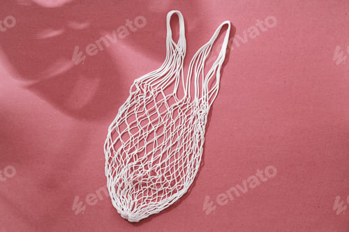 Preview: Empty string reusable bag on paper background, top view