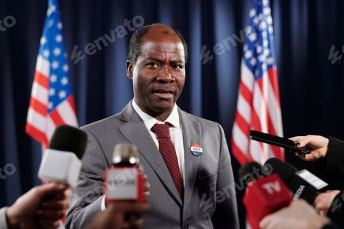 Preview: Mature African American deputy in formalwear speaking in microphones