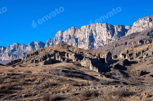 Preview: Rocks and dry grass in North Caucasus mountains in autumn on sunny day