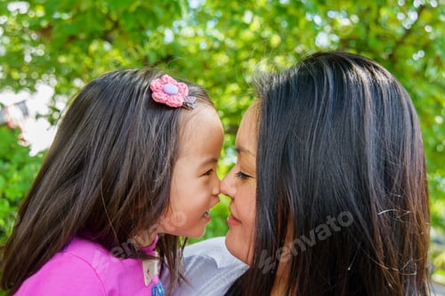 Preview: Portrait of mid adult mother and girl toddler nose to nose