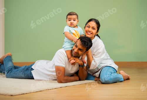 Preview: Smiling Family Relaxing on the Floor at Home