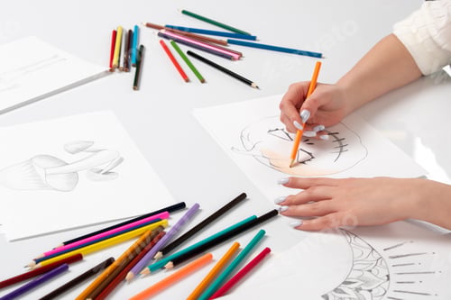 Preview: Drawing a young girl hand drawing a halloween pumpkin and painting with orange pencil