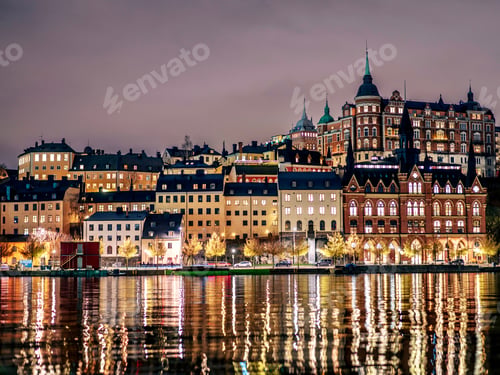 Preview: Buildings line the shore of a tranquil body of water in the evening in Stockholm, Sweden