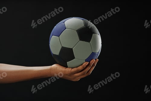 Preview: Hand Holding Football Ball with Copy Space