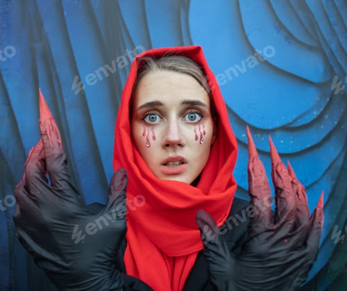 Preview: Beautiful girl with Halloween make-up and handmade gloves with bloody clowes