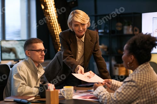 Preview: Mature Caucasian Woman Leading Business Meeting with Diverse Colleagues Collaborating