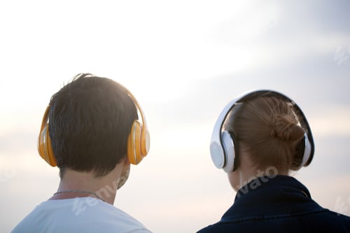 Preview: Young people in headphones enjoying music outdoor