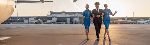 Preview: Happy Pilot and Attendants Walking on Runway