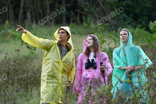 Preview: Hikers walking along a trail on a mountain with hiking sticks
