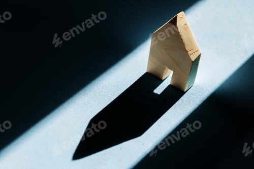 Preview: Miniature wooden house with shadows on blue background