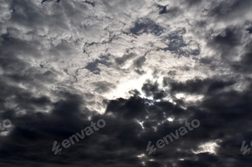 Preview: Dramatic stormy sky background. Dark gray fluffy cloudy sky.