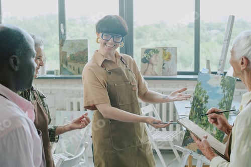 Preview: Proud Smiling Teacher Demonstrating Own Work of Art