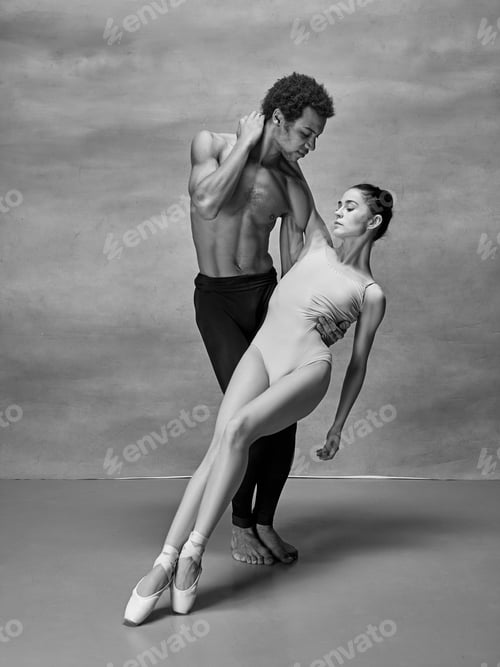 Preview: Couple of ballet dancers posing over gray background