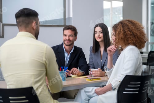 Preview: Business team collaborating on project in modern office