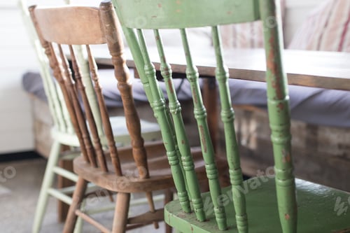 Preview: Row of rustic timber chairs in a family living area with a timber table, cushions and natural light