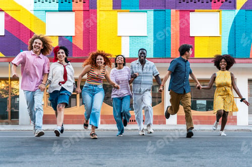 Preview: Multiethnic group of young friends meeting and having fun outdoors