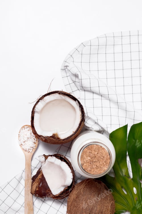 Preview: Coconut milk in glass bottle. Whole and cracked coco. Flat lay, top view isolated on white