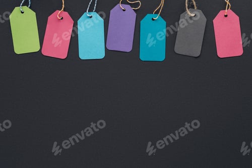 Preview: top view of colorful sale tags on black background with copy space for black friday