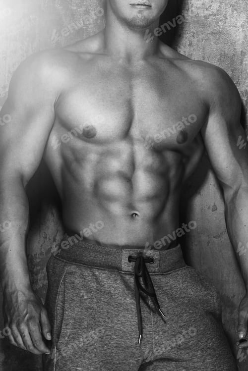 Preview: Young strong bodybuilder showing hiis muscular torso