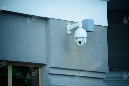 Preview: close up view of security camera on gray building facade