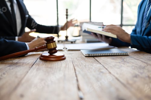 Preview: Lawyer is giving legal advice to a businessman in the legal counsel's office.