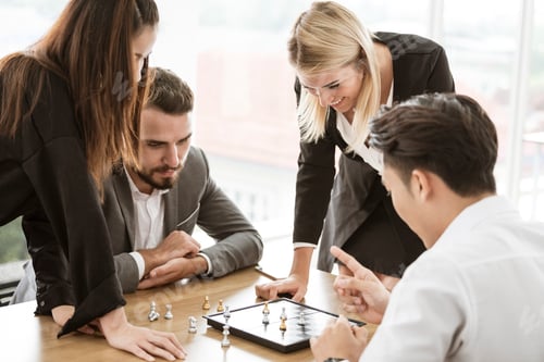 Preview: Collaborative process of skilled person brainstorming play chess game in office.