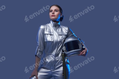 Preview: Modern female cosmonaut posing against blue background