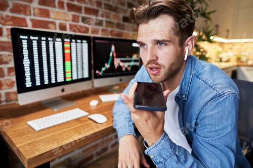 Preview: Busy young man talking by mobile phone