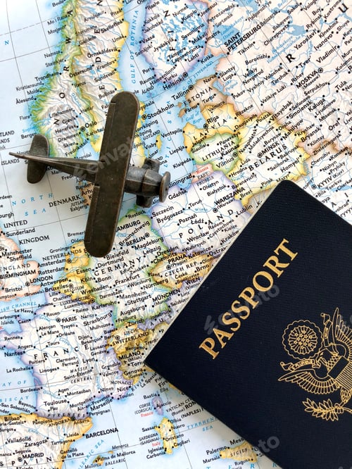 Preview: Flat lay overhead of airplane & passport on a map for travel the world concept