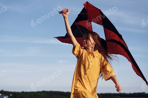 Preview: Running with kite. Happy girl have a walk outdoors on the field at summer