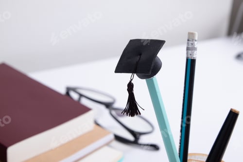Preview: A cap on a pencil on the background of a desktop with office supplies. Online home learning concept