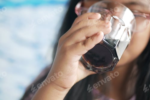 Preview: little girl enjoying a refreshing drink on a sunny day