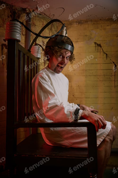 Preview: Crazy man screaming feeling madness on electric chair at psychiatric hospital