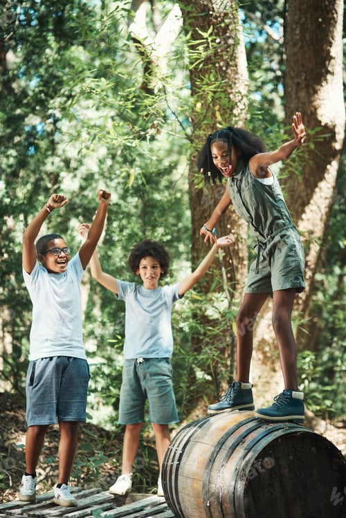 Preview: Shot of a group of teenagers having fun with a barrel in nature at summer camp
