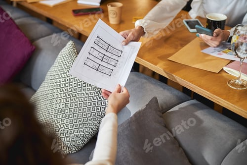 Team Collaborating on Blueprints at a Modern Workplace