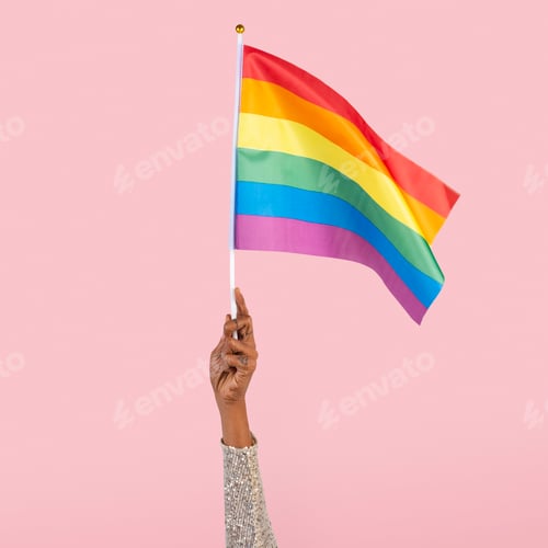 Preview: LGBTQ+ pride flag with woman’s hand raising