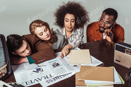 Preview: multicultural retro styled journalists reading newspapers isolated on grey